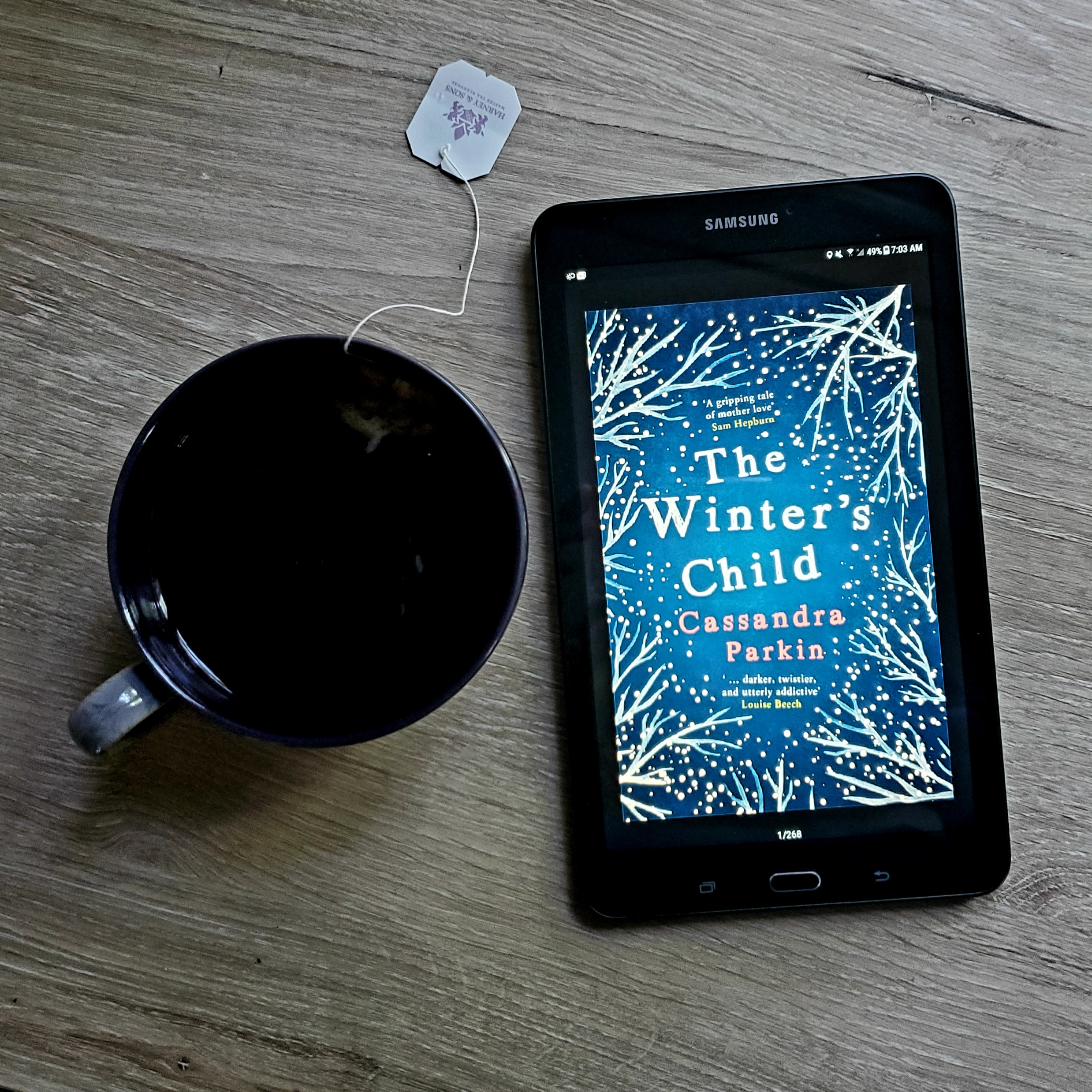 The Winter's Child book flatlay and teacup