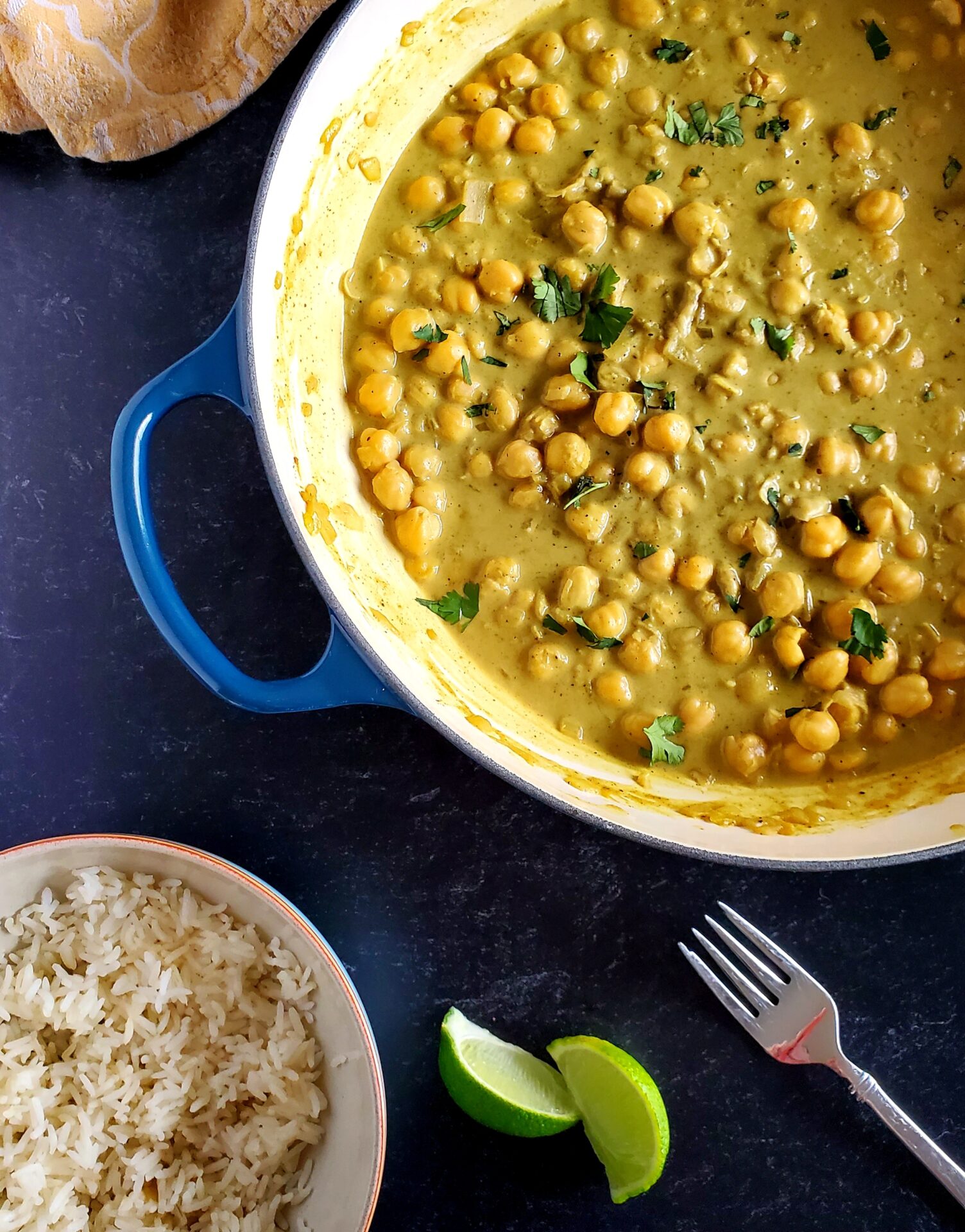 chickpea curry, rice, and lime wedges