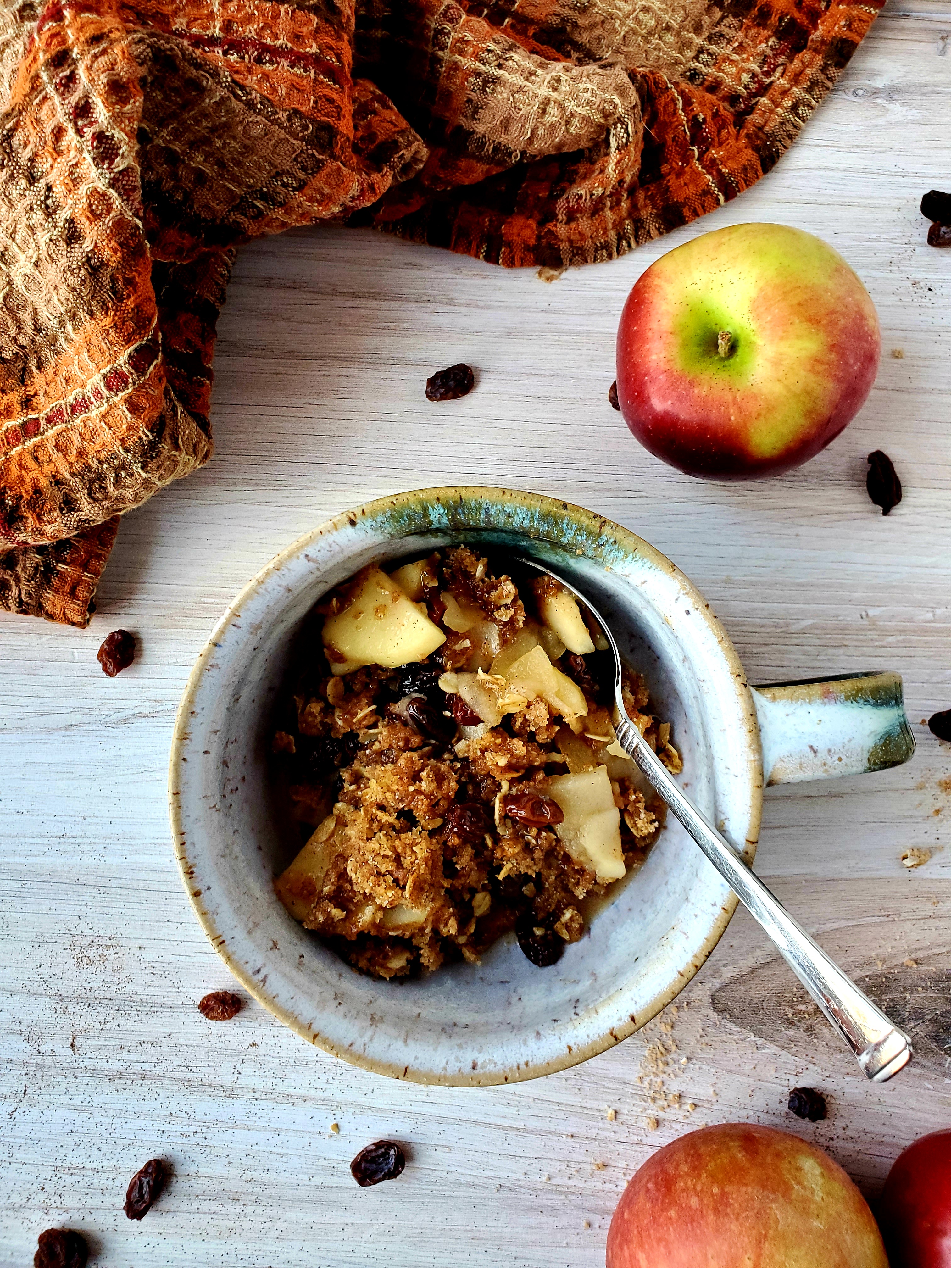 apple crumble in bowl with spoon