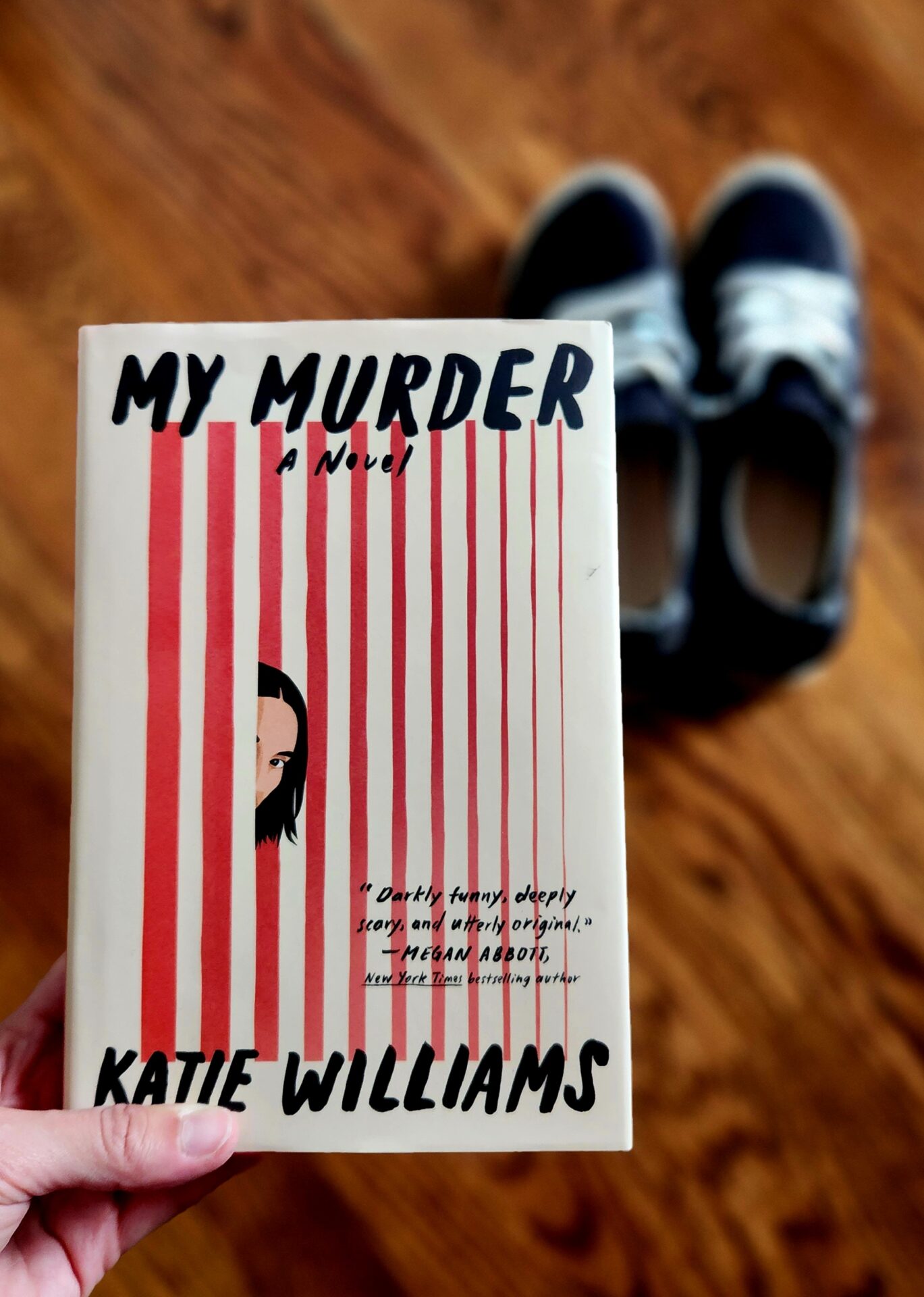 book cover of my murder with running shoes in the background